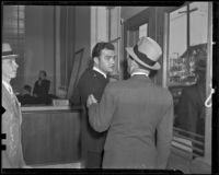Edward Hill, bank guard, turns to talk to a man after the bank was robbed, Los Angeles, 1936