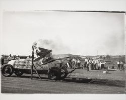 Car crashing through a wall of fire at Di Grazia Motordrome, Santa Rosa, California, 1939