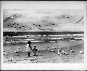 Children on the shore at Long Beach surrounded by seagulls, ca.1900