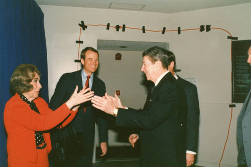Margaret Brock and President Reagan reaching out to each other