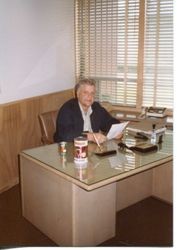 Donald O. Hallberg sitting at his desk at the office of O. A. Hallberg & Sons at 2999 Bowen Avenue, Graton, March, 1983