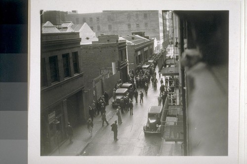 [View from third floor showing crowd of people on street]