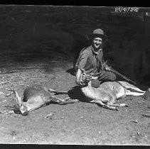 Man with two dead deer