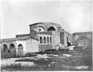 Exterior view of the Mission San Juan Capistrano taken by photographer Edward Vischer showing the bell tower and altar, before 1875