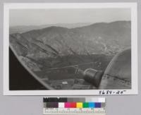 The firebreaks and roadways in the Angeles National Forest above San Fernando Valley from northbound plane from Burbank. Metcalf. December 1952