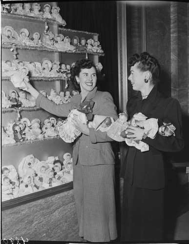 Two ladies with Christmas doll display