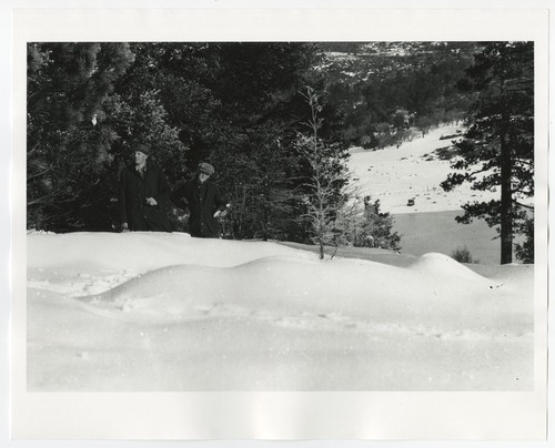 Unidentified men in snow-covered grounds at Lake Cuyamaca