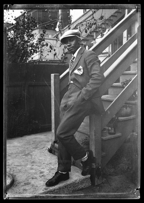 E.F. Joseph leaning against front porch railing