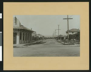 Main Street in Highland, with a horse tied up to a telephone pole in front of a house, ca.1905