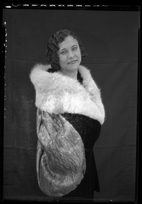 Portrait of a young woman in a fur coat