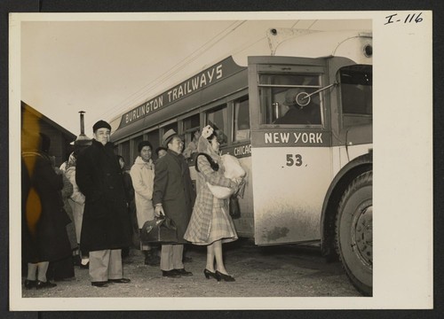 Mr. and Mrs. Thomas Oki and daughter Dinne, about to board the bus from Heart Mountain Relocation, Wyoming, on their