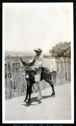David "Bil" Espinoza Arce riding a burro in El Rosario