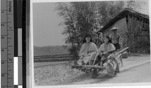 Sister Dominic Marie Turner, MM, and a Chinese Sister riding in a wheelbarrow, Pingnam, China, 1939