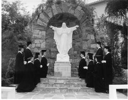 Marymount students in front of Jesus statue