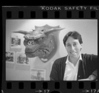 Producer-director Ivan Reitman posing with head of Terror Dog creature from "Ghostbusters" movie, 1984
