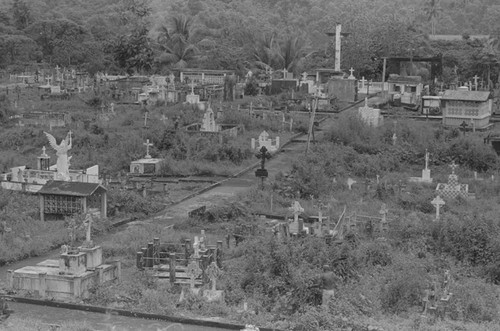 Distant view of a man landscaping a cemetery, Barbacoas, Colombia, 1979