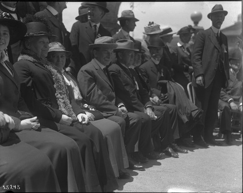 Group of men and women sitting outside