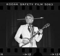 Steve Martin playing the banjo with arrow through head, 1978