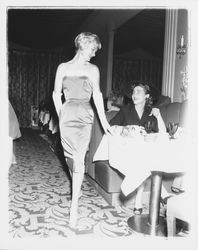Model in evening dress and Topaz Room customer in the "Dramatic Moods" fashion show in the Topaz Room, Santa Rosa, California, 1959