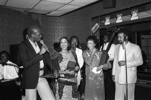 Wilton Felder, Ndugu Chancler, and Joe Sample standing with Reve and Gertrude Gipson,1984
