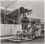 [Exterior general view of forklift with scaffolding, Newberry Electric Corporation, on bridge]