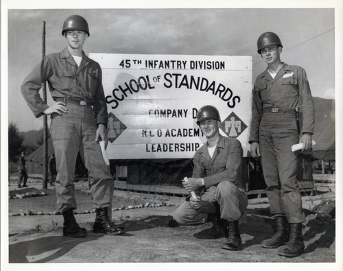 Soldiers posing with sign at NCO school in Korea
