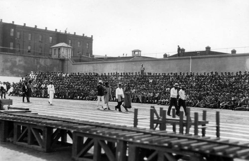 Parade of prisoners, some in female dress, San Quentin Little Olympics Field Meet, 1930 [photograph]