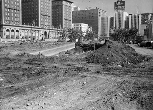 View of the Pershing Square garage construction site, looking northwest from Sixth Street, showing the Blitmore Hotel in the background, ca.1955