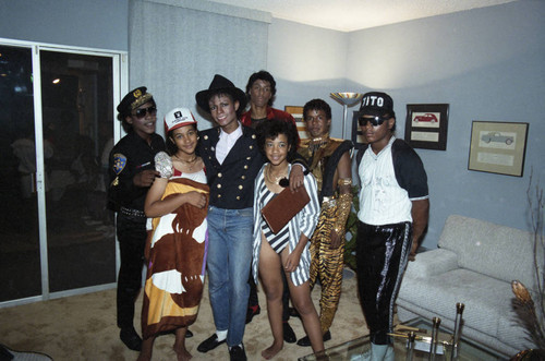 Jackson 5 impersonators posing with guests at Berry Gordy's party, Los Angeles, 1984