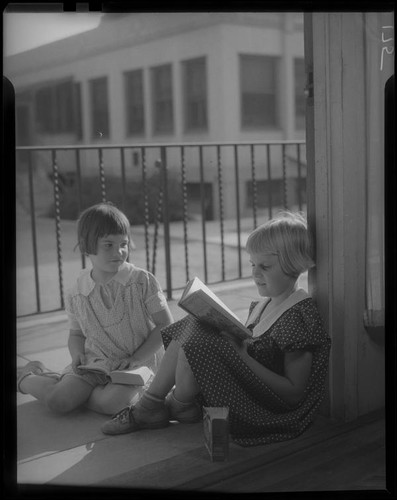 Girls reading on porch or patio, Los Angeles, circa 1935