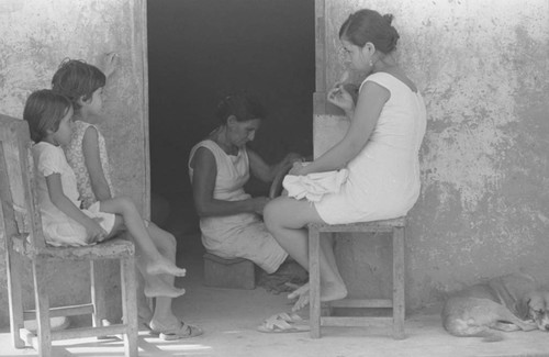 Woman and children sitting outside, La Chamba, Colombia, 1975
