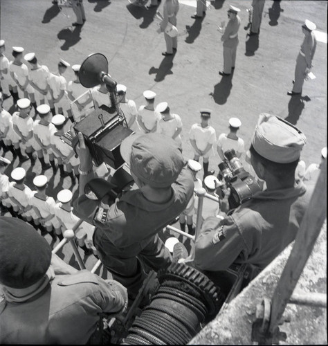 Photographers documenting ceremony on the deck of a British aircraft carrier