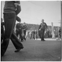 Police and strikers in the background during the Conference of Studio Unions strike against all Hollywood studios, Los Angeles, October 19, 1945