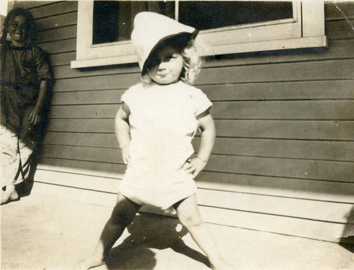 Micky Moore as a toddler posing with hat