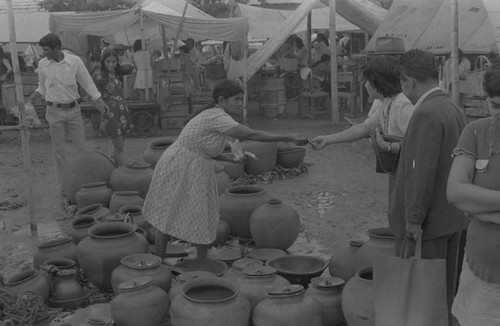 Woman selling clay goods at the market, La Chamba, Colombia, 1975