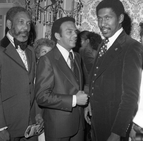 Andrew Young talking with others at a Brotherhood Crusade dinner, Los Angeles, 1978