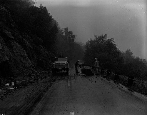 J.L. Sperber, General's Highway just below 4000' elevation. Floods and Storm Damage, Large boulder on highway. Individuals Unidentified. Maintenence Activities. 630201