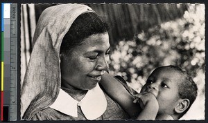 Papuan sister holding a baby orphan, Papua New Guinea, ca.1900-1930
