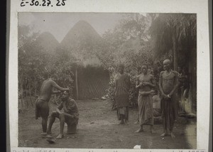 Bali compound, with a wife shaving her husband