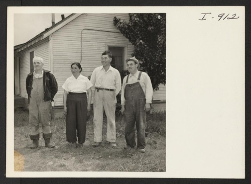 Mr. and Mrs. Y. Mishima, are shown with two Caucasian neighbors on the berry ranch near Gresham, Oregon. The Mishimas