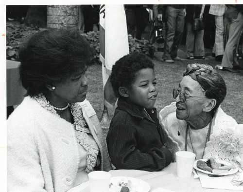 Pearl Williams speaking with a young boy and Betty Smith during foster grandparents ceremony, 1975