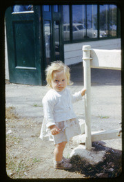 Little Girl Holding Onto A Metal Post