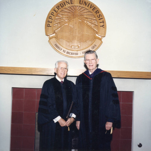 William Leonhard and Chancellor Runnels standing in front of the Pepperdine University Seal