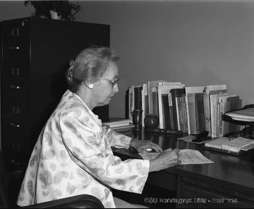 Dr. Marion Buck working at desk