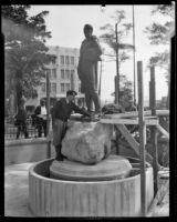 Sculptor Henry Lion competing the installation of his statue of Felipe de Neve in La Plaza Park, Los Angeles, 1932