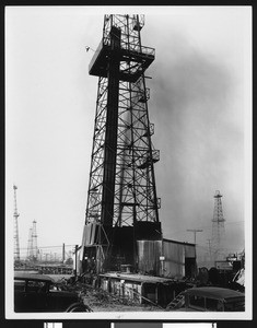 Oil sprouting from a derrick at the Playa del Rey oil field in Venice, ca.1925
