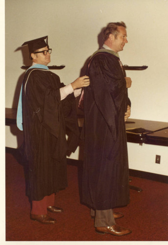 Bert Brewer assisting Walter Glass with his robing