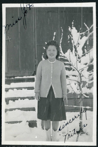 Photograph of Mitzie standing in the snow at Manzanar
