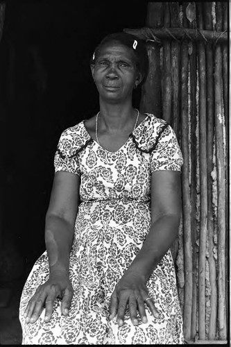 A woman sits by a doorway, San Basilio de Palenque, 1975