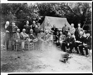 Members of the Sunset Club seated around a campfire, ca.1905